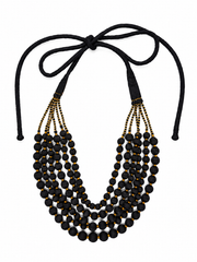 A 5 or 6 multi-strand statement necklace featuring round beads wrapped in black sari fabric with gold stitching in between and black cords tied at the top,  allowing  for various lengths of wear.